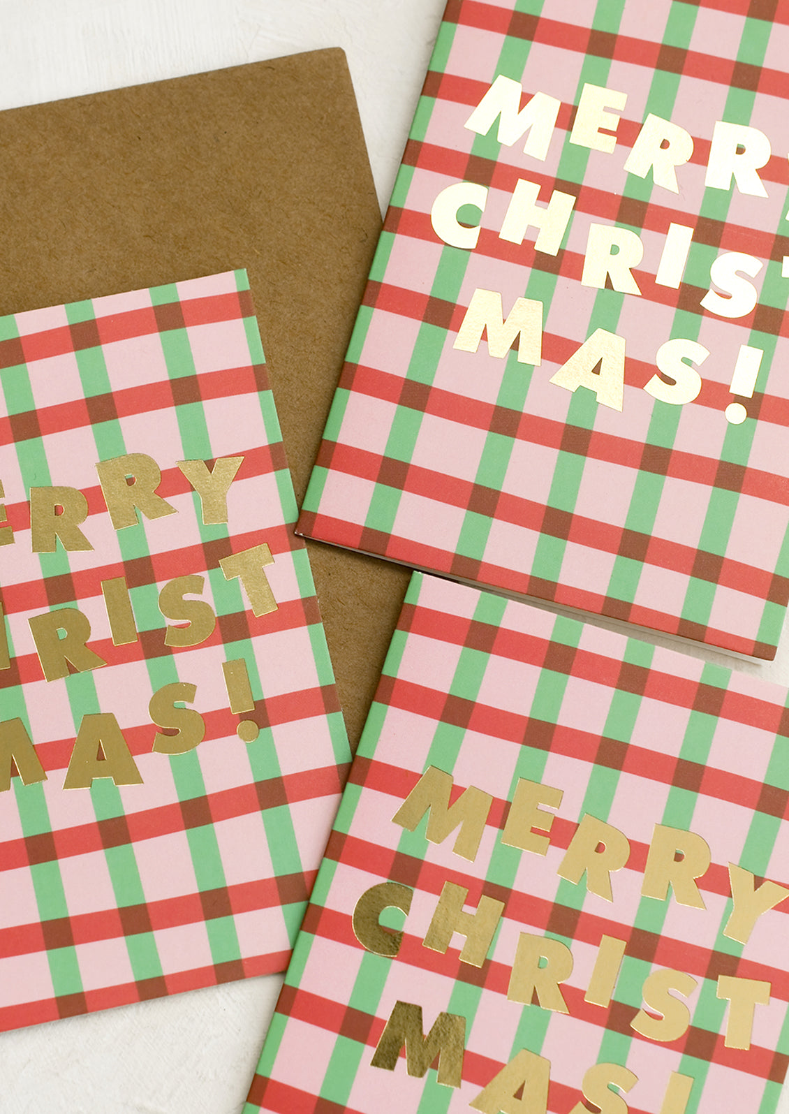 A set of red and green plaid Christmas cards.