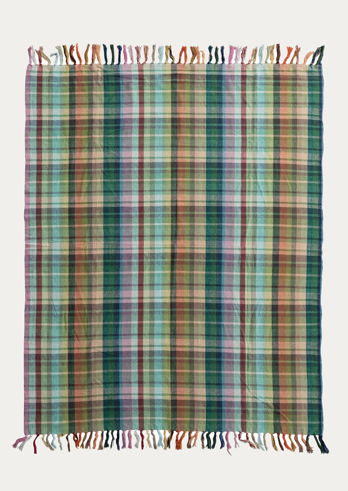 Multicolored plaid blanket with tassels on a white background