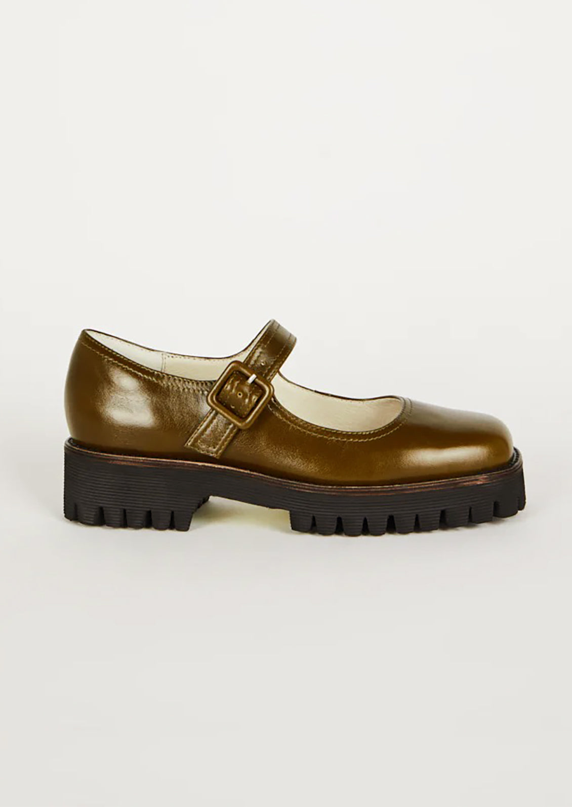 A pair of mary jane shoes in olive green with chunky lug sole.