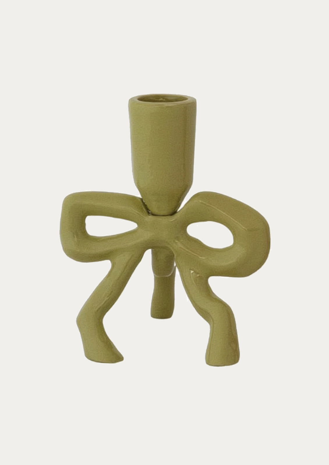 Green enamel candle holder with a bow design on a white background