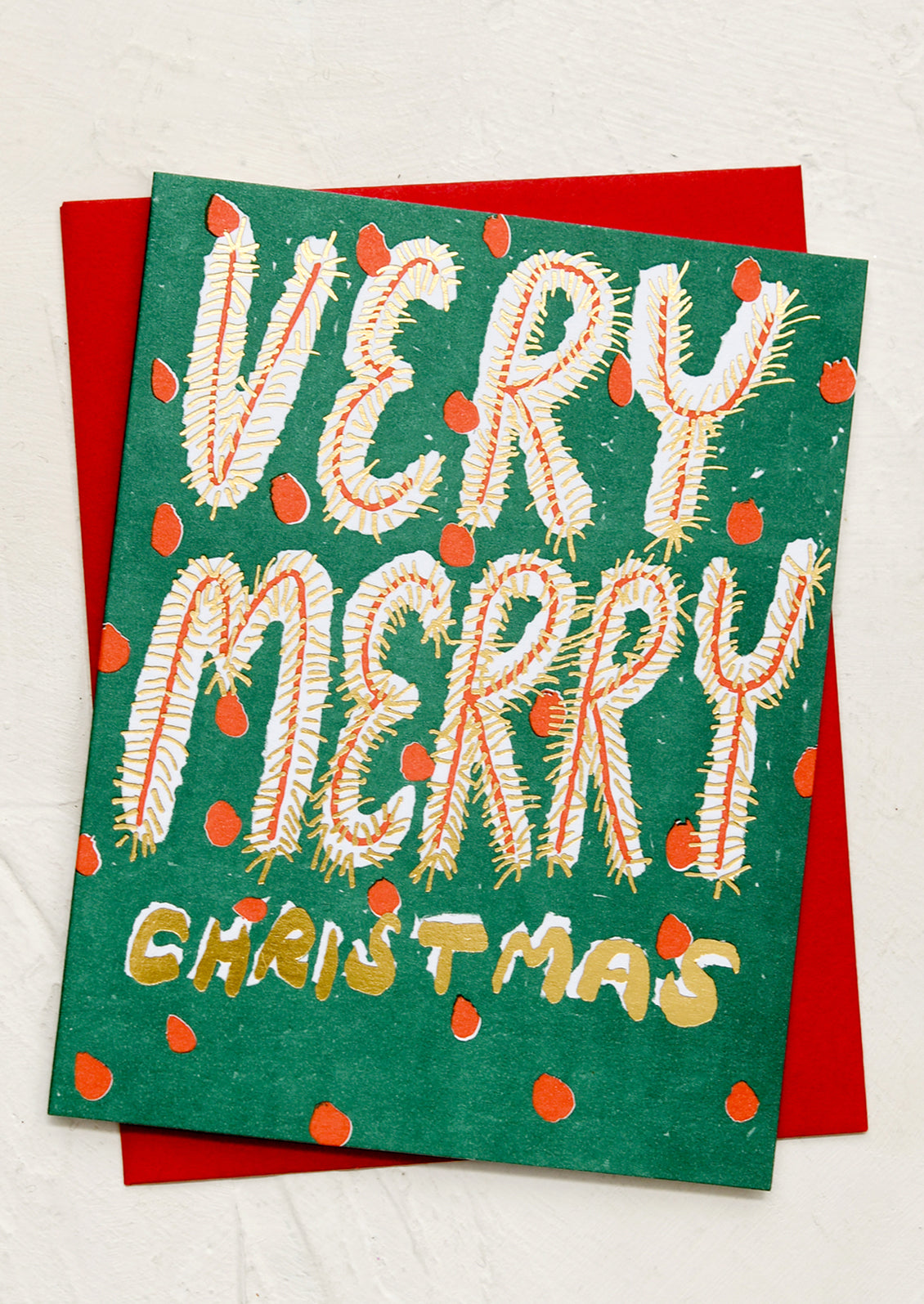 A card in red and green with text reading "Very Merry Christmas".