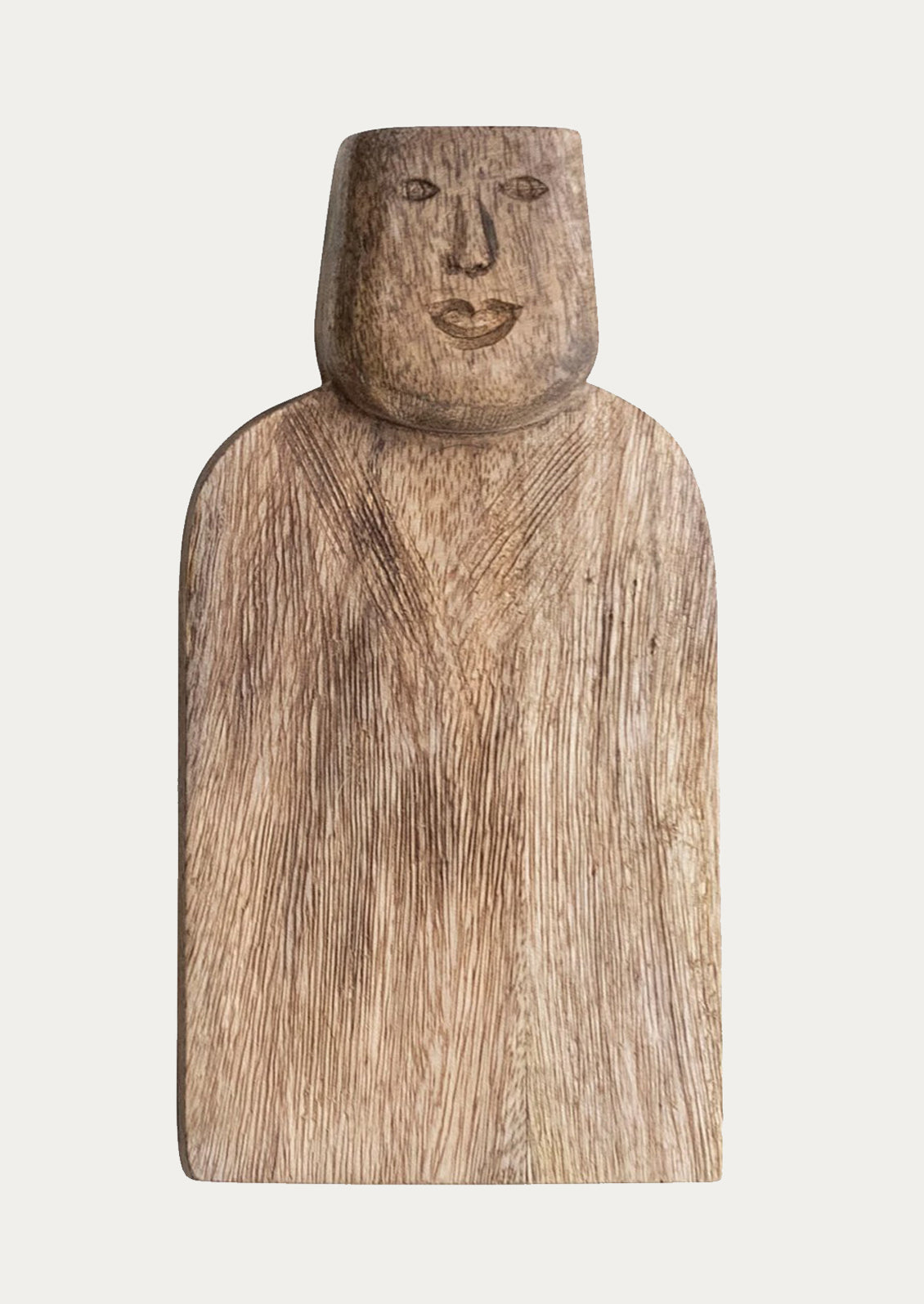 A small wooden serving board with a face carved into the handle.