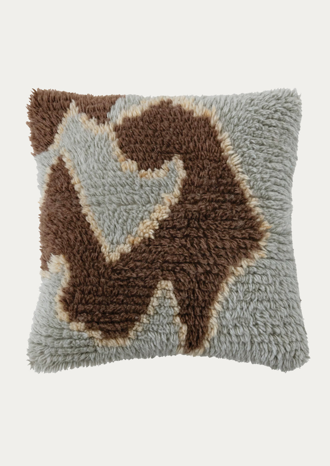A wool shag throw pillow in seafoam with abstract shape in brown and yellow.