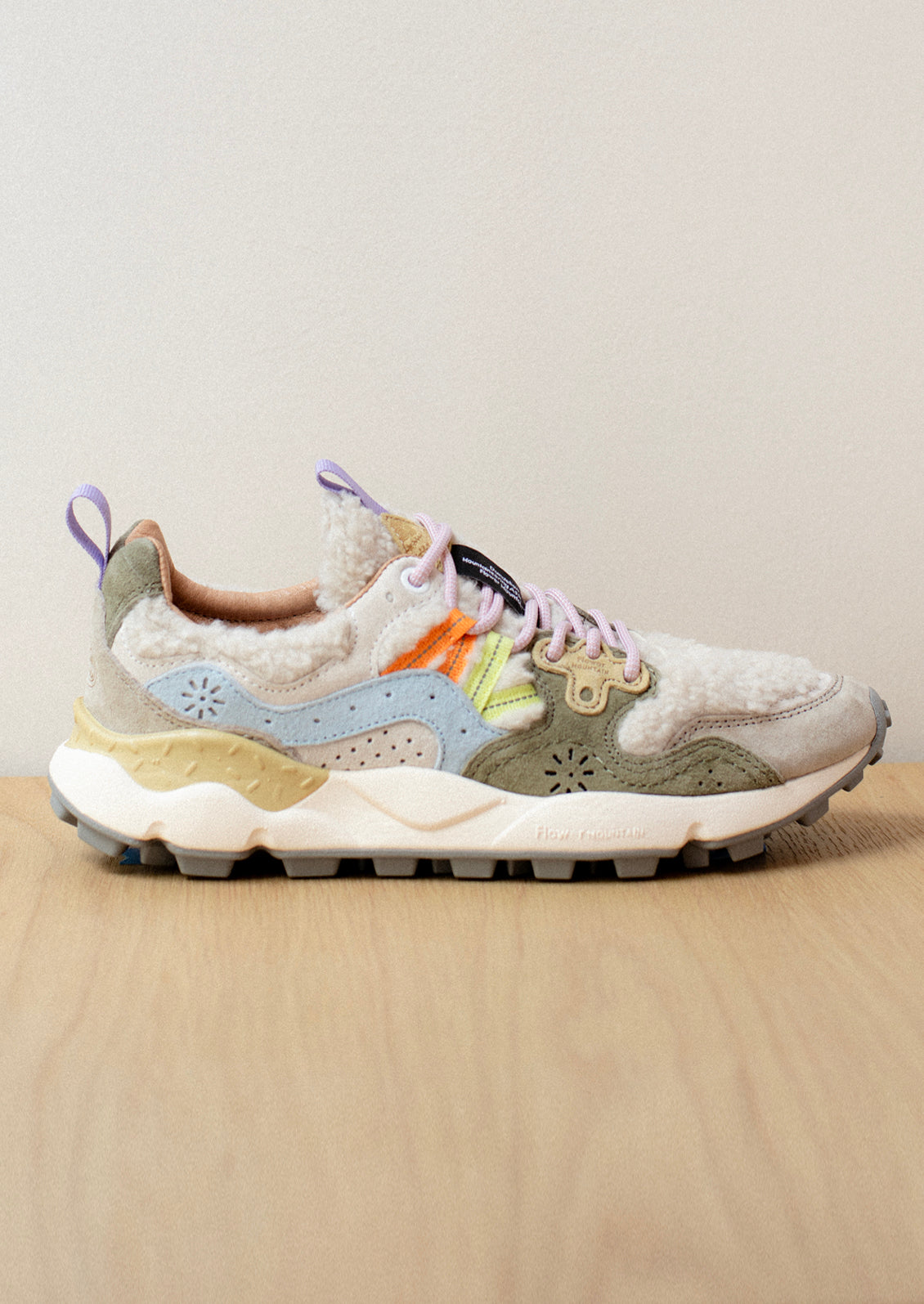 A pair of sporty sneakers in pastel multicolor with cream shearling upper.