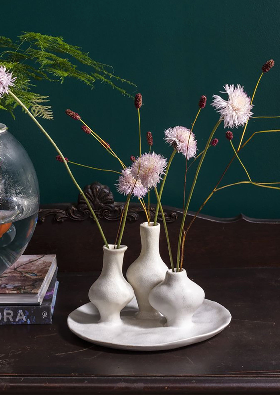 A sculptural multi vessel plate with bud vases in white ceramic.
