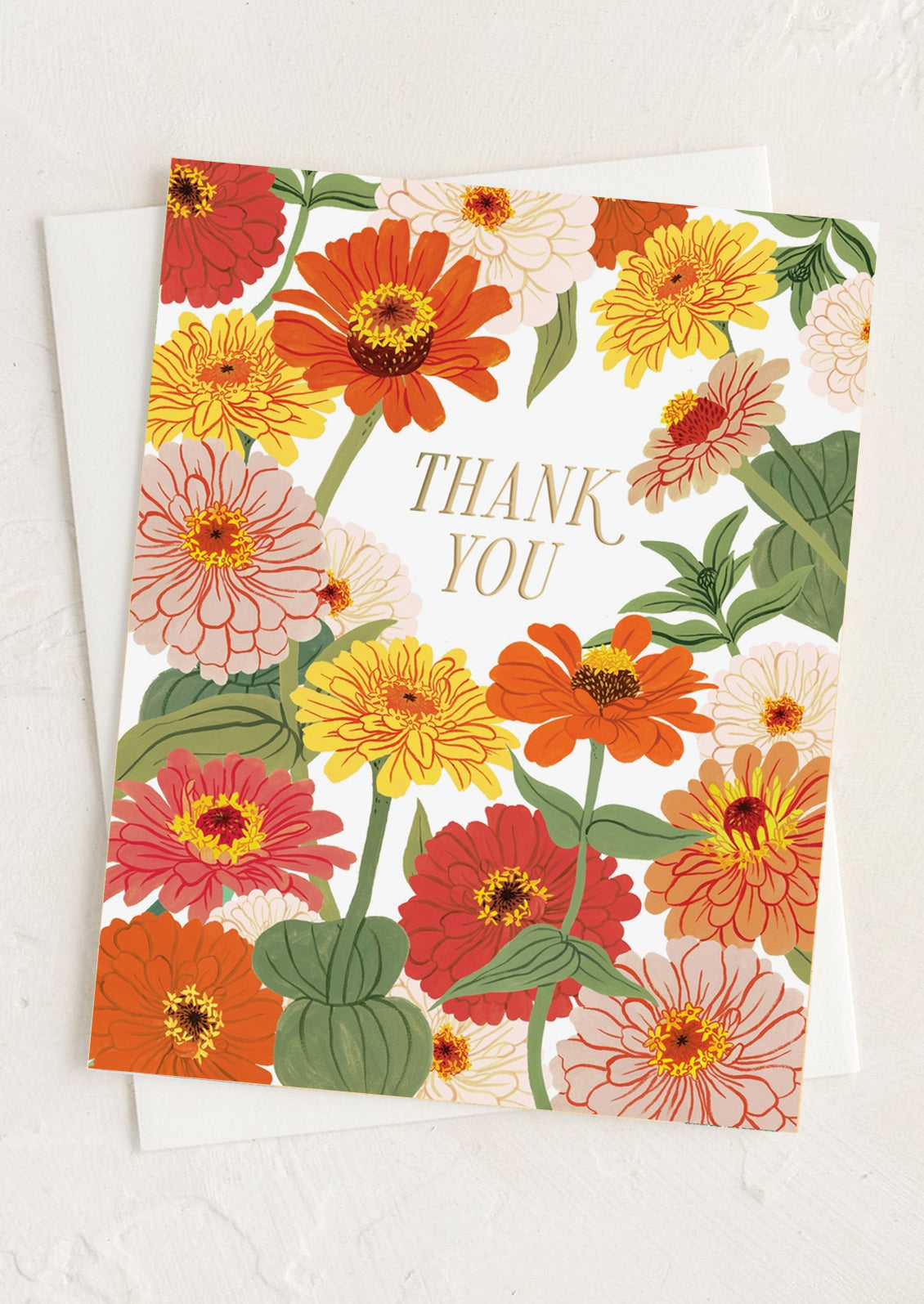 A zinnia print greeting card with gold "Thank you" text.