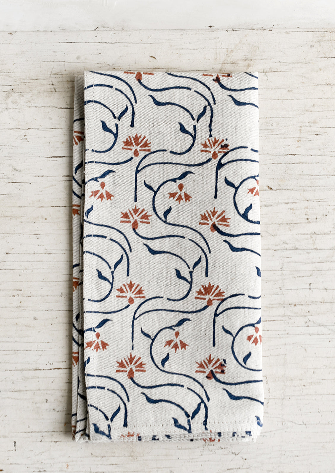 A block printed linen napkin with floral line print.