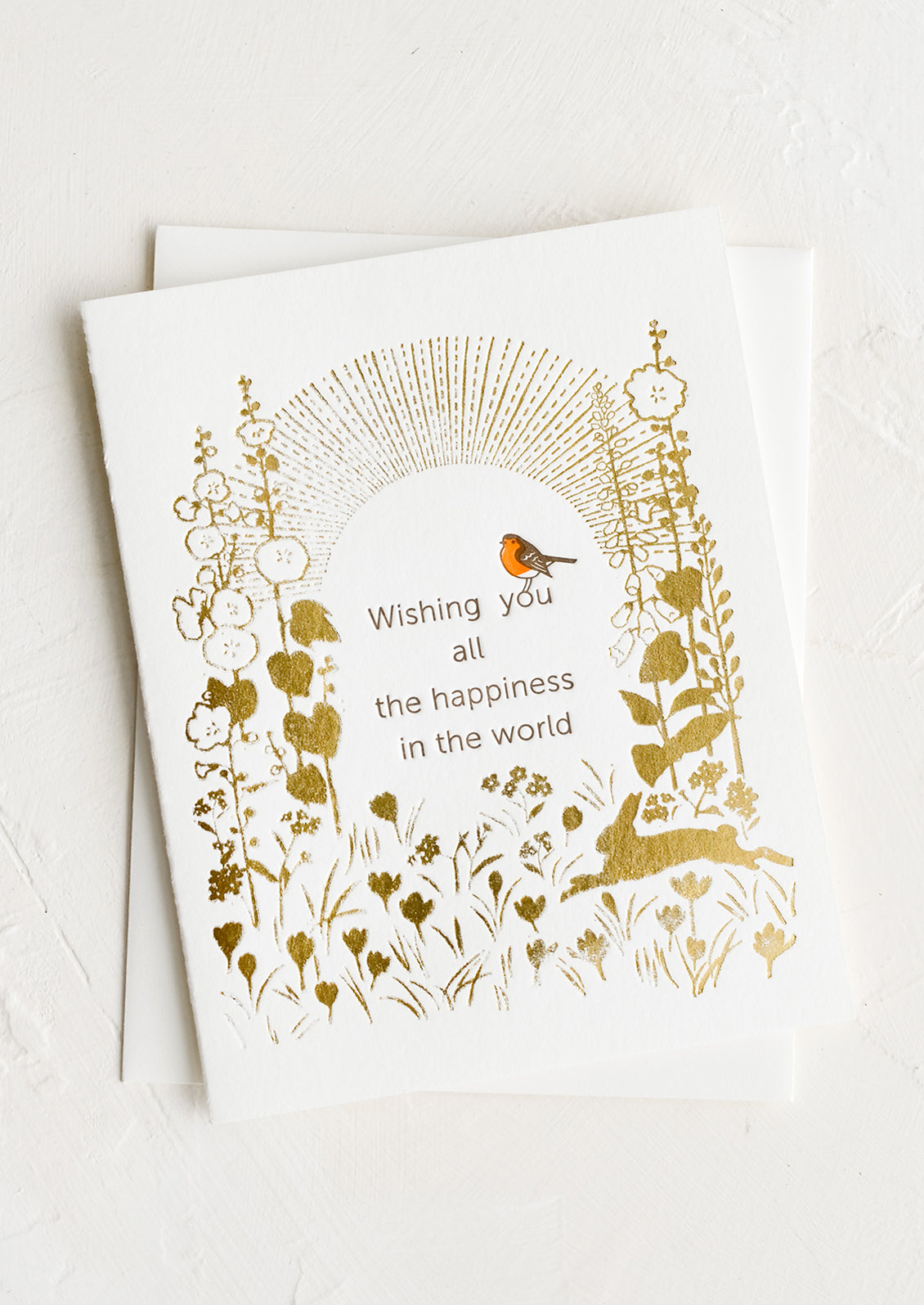 A greeting card reading "wishing you all the happiness in the world".