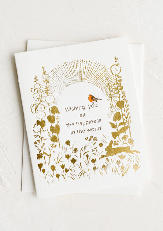 A greeting card reading "wishing you all the happiness in the world".