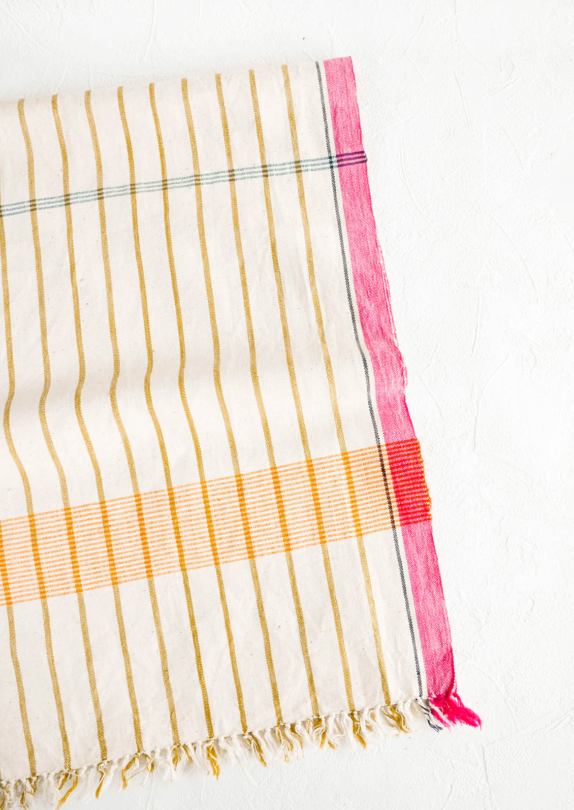 Cotton table runner in plaid/stripe print in a mix of bright colors
