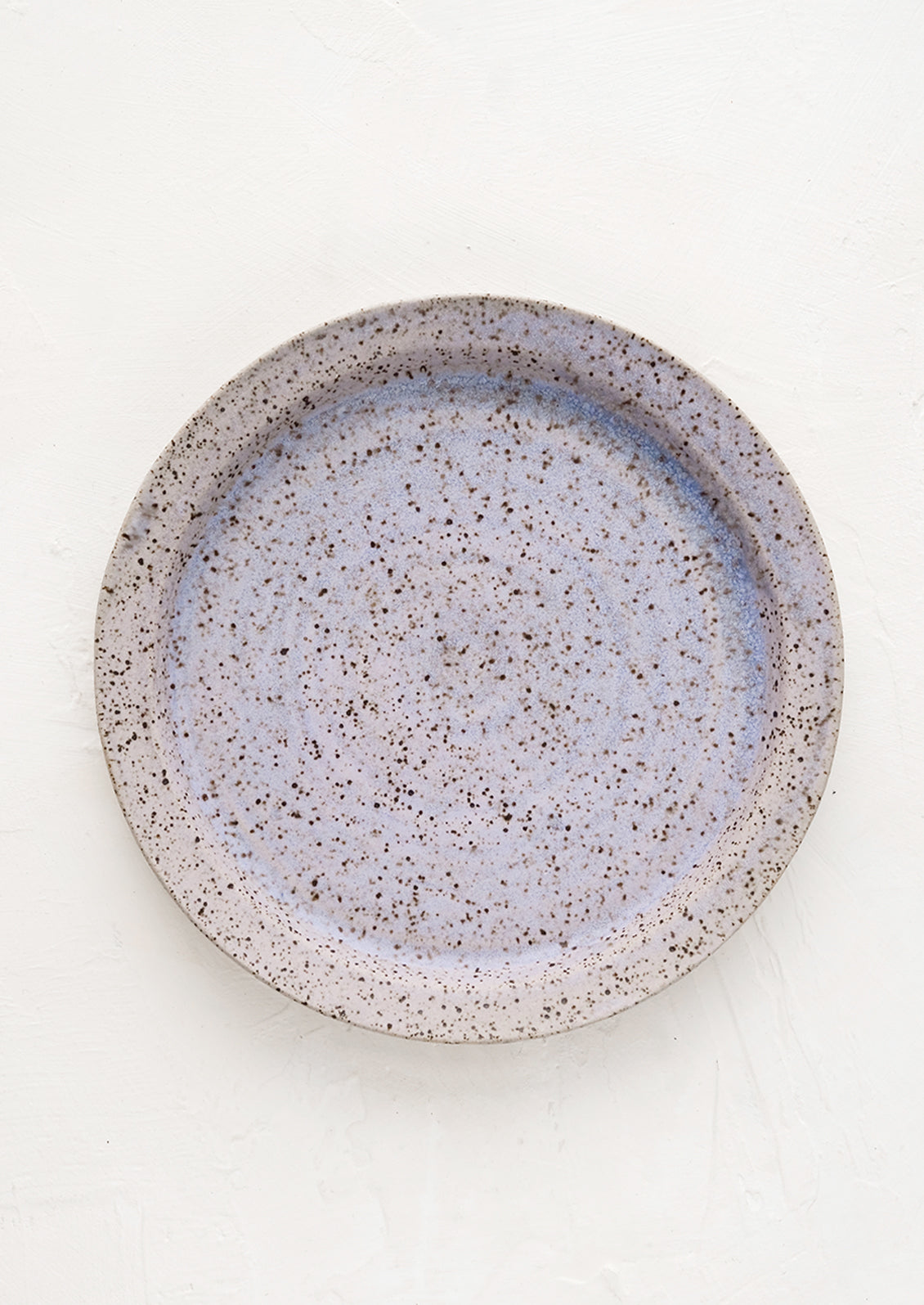 A ceramic side plate in lavender speckle glaze.