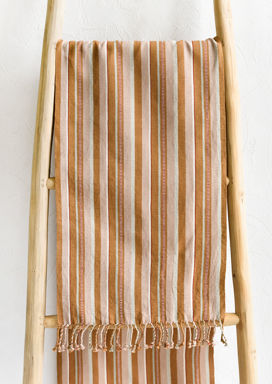 A tan striped table runner.