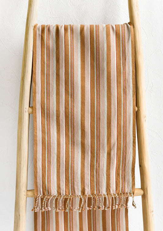 A tan striped table runner.