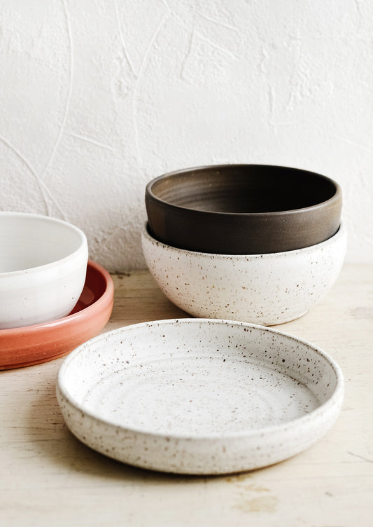 A collection of handmade ceramic bowls in various colors and sizes.