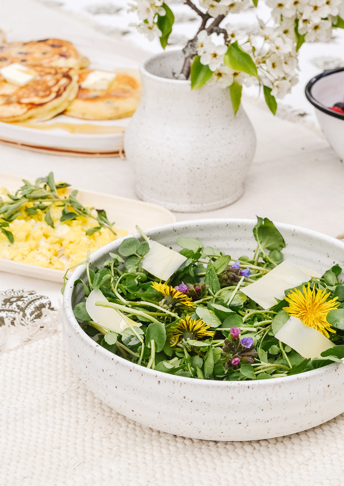 A tabletop scene with ceramic serving pieces.