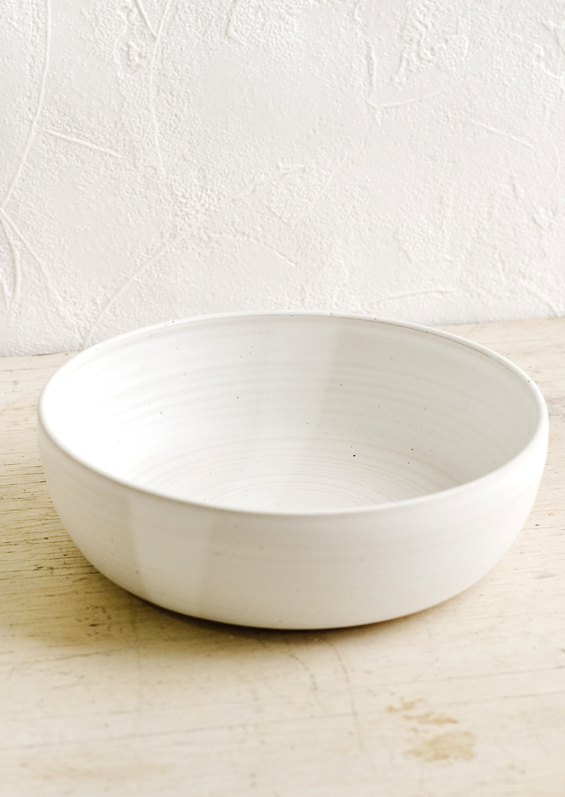 A ceramic serving bowl in matte white.