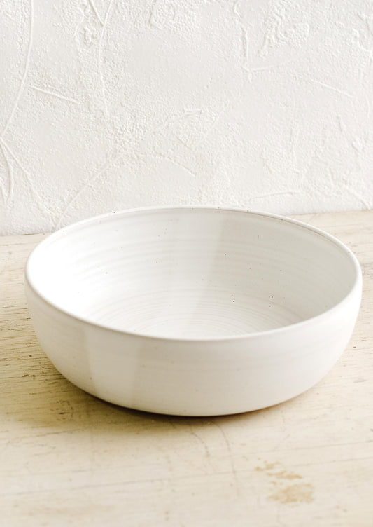 A ceramic serving bowl in matte white.