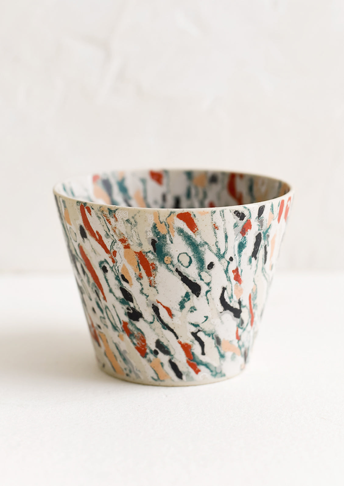 A marbleized porcelain cup.