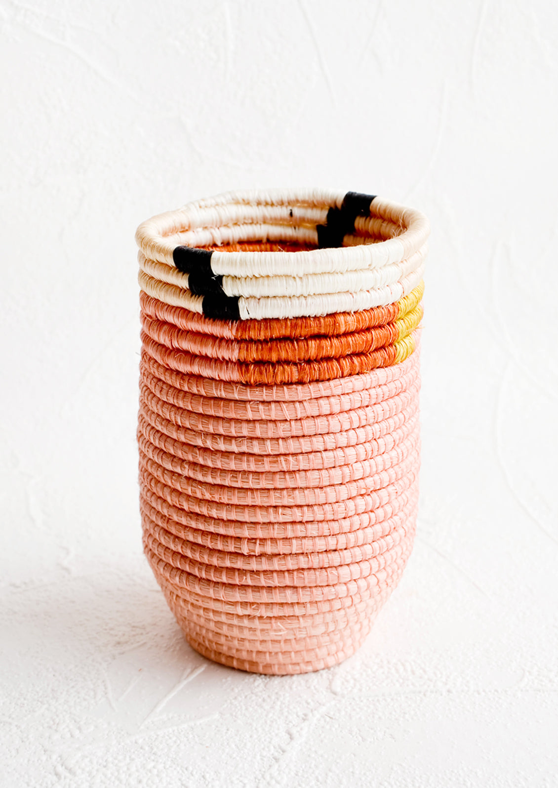 Pencil cup shaped woven sweetgrass basket in pink color combo with geometric trim
