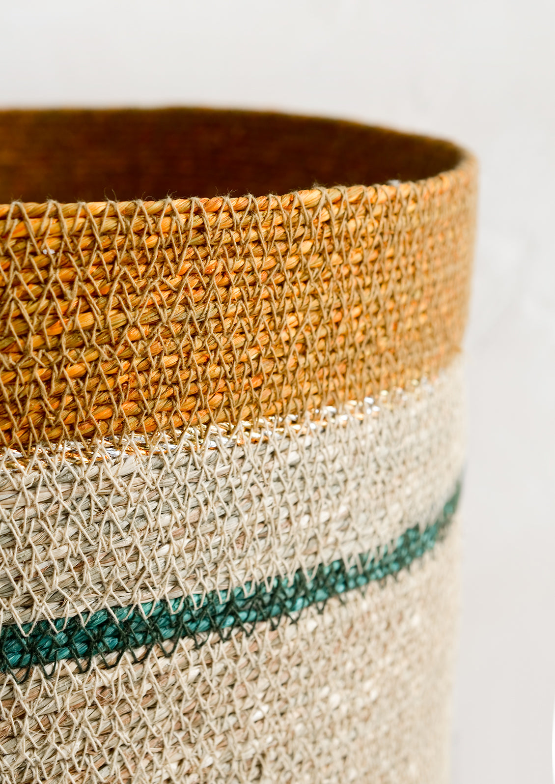 Silver and gold metallic detailing on a storage basket.