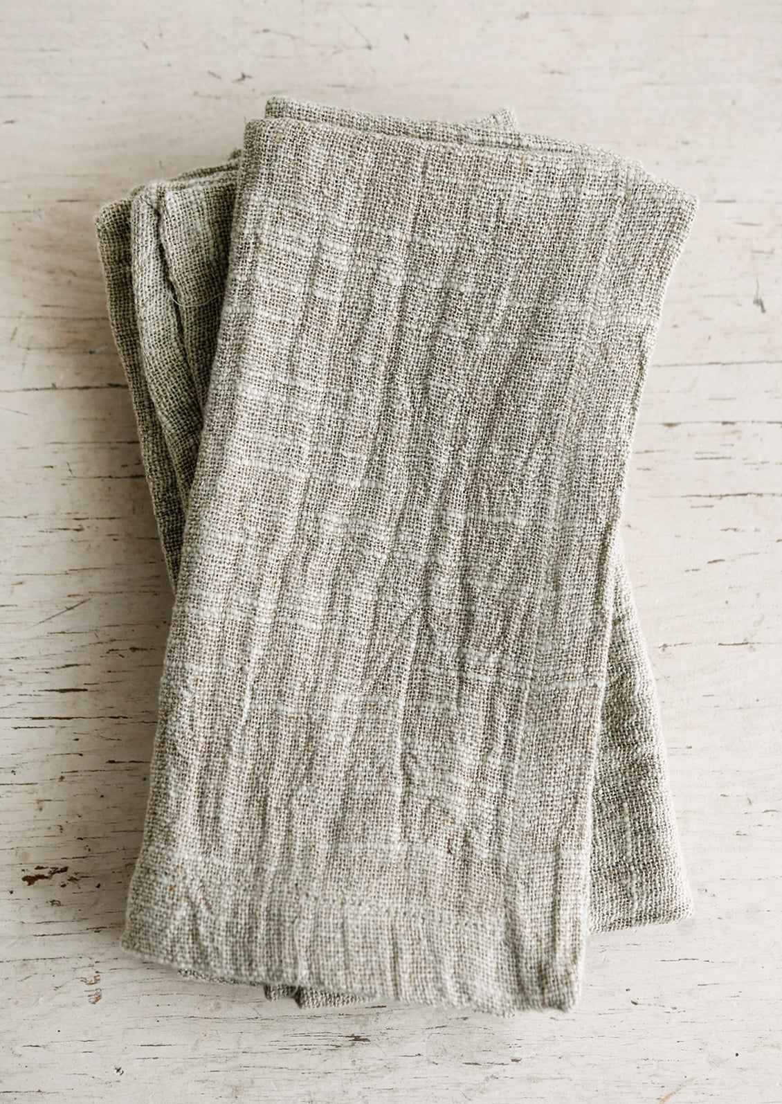 Slub textured linen-cotton napkins folded on a table.