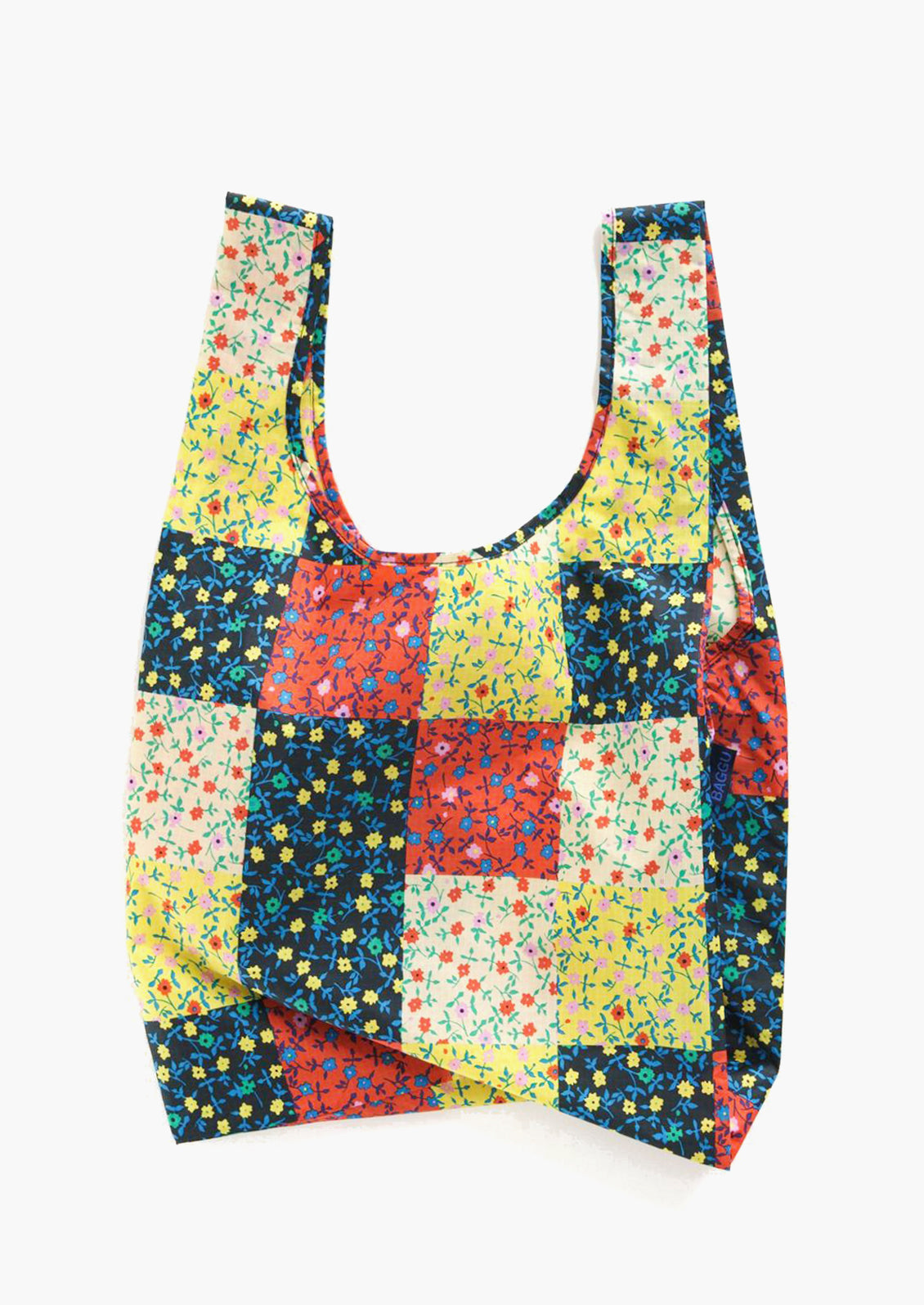 A reusuable standard Baggu bag in calico block print.