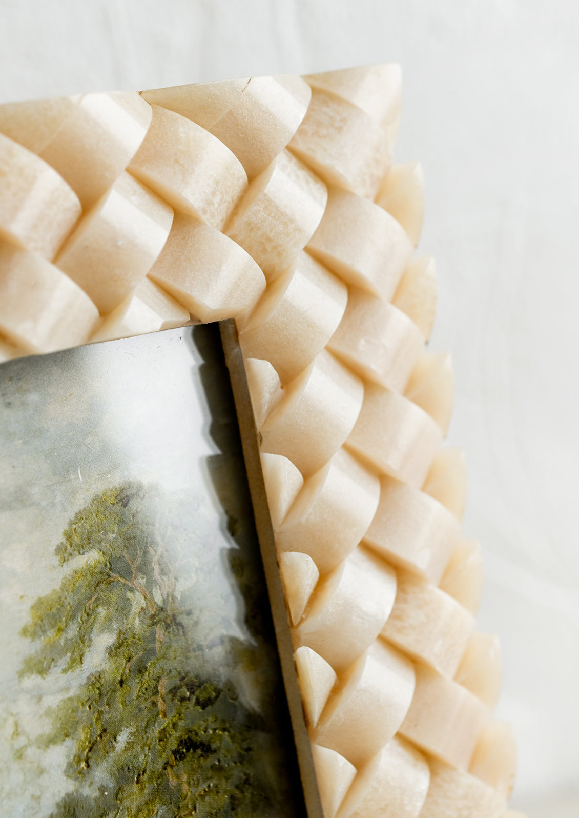 A resin picture frame in tan with basketweave texture.