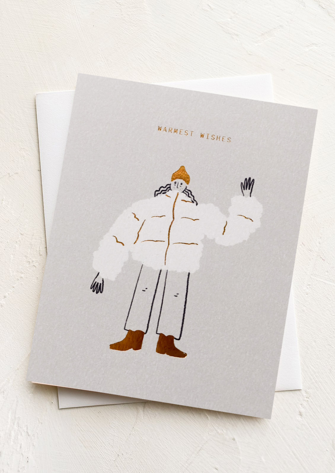 A greeting card with illustration of girl in a puffer coat waving, text reads "Warmest wishes".