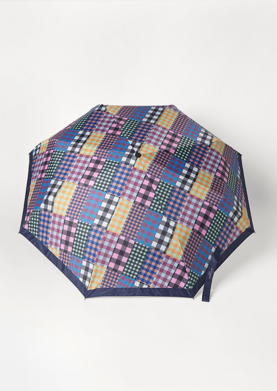A nylon umbrella in checkered patchwork print.