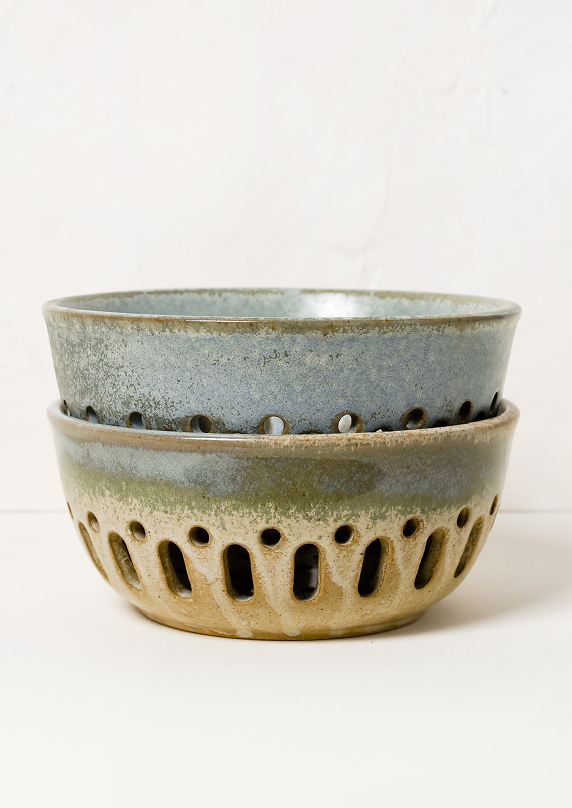 Ceramic berry colanders in mottled glazes.