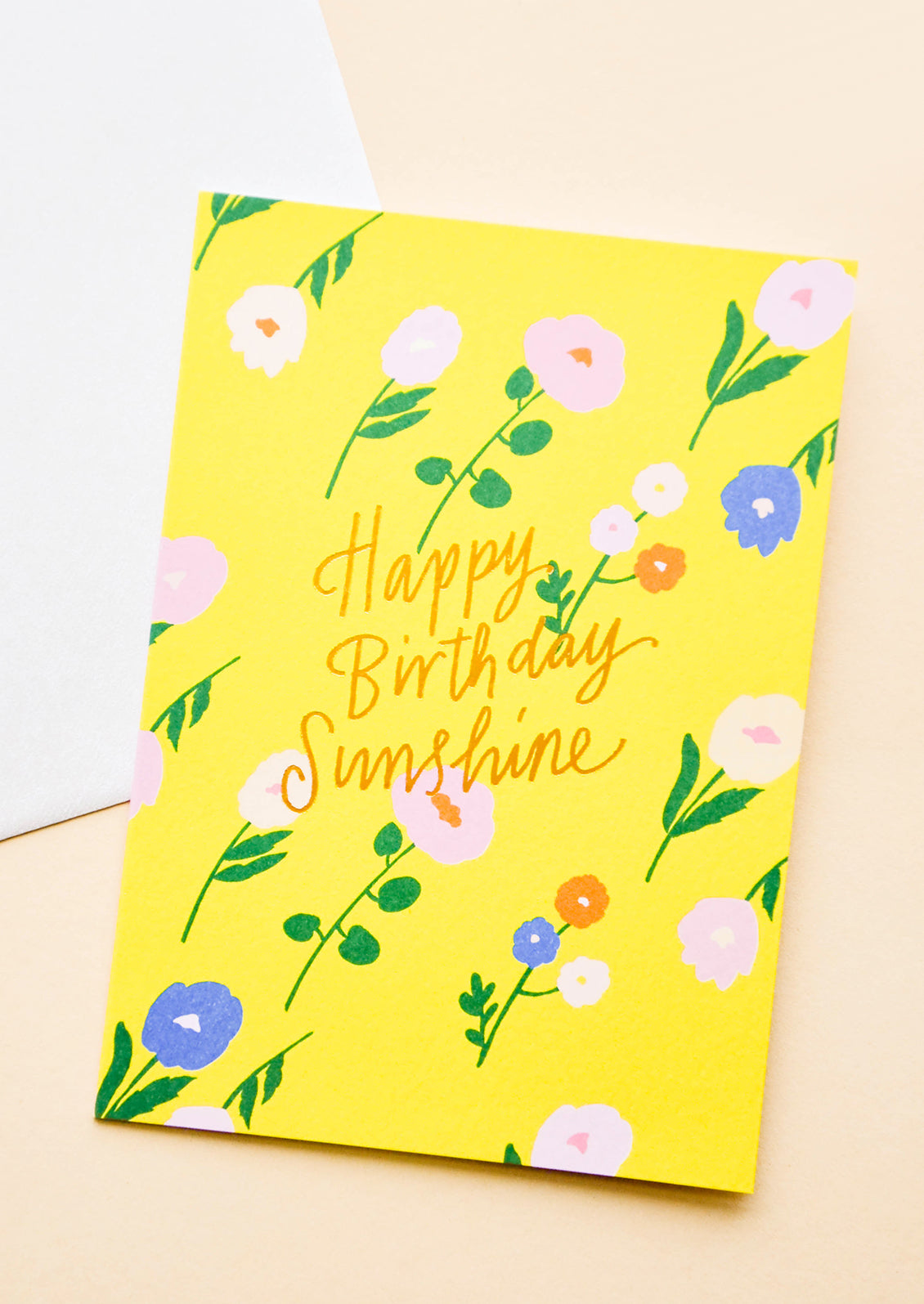 Greeting card in sunny yellow with flowers and "Happy Birthday Sunshine" in gold text