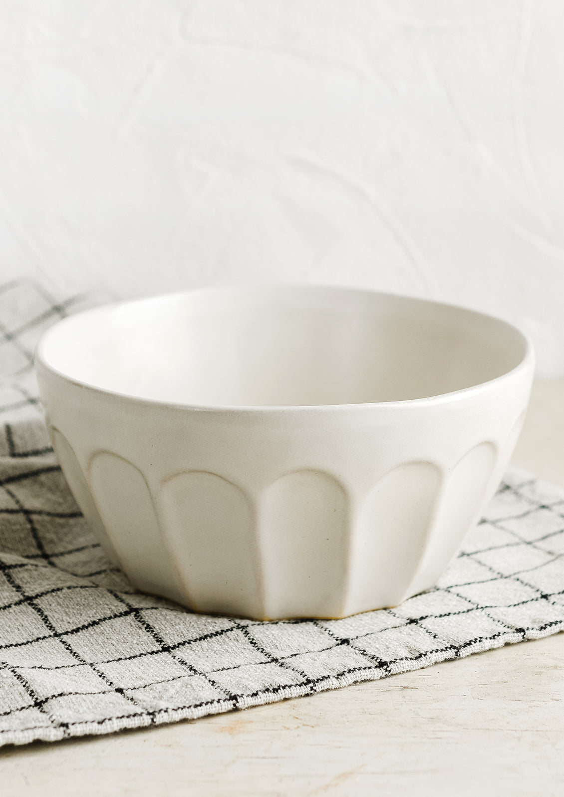 A white bowl with classic bistro style texture.