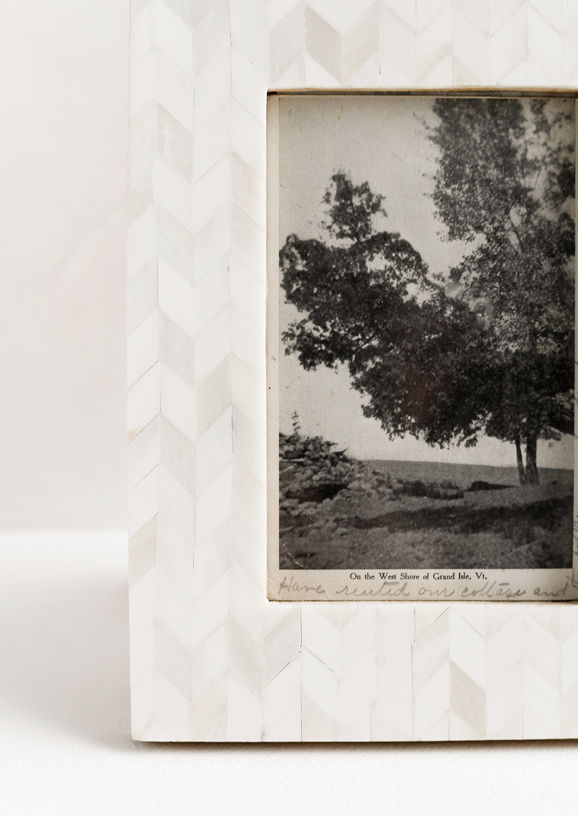 A picture frame in chevron pattern made from ivory bone.