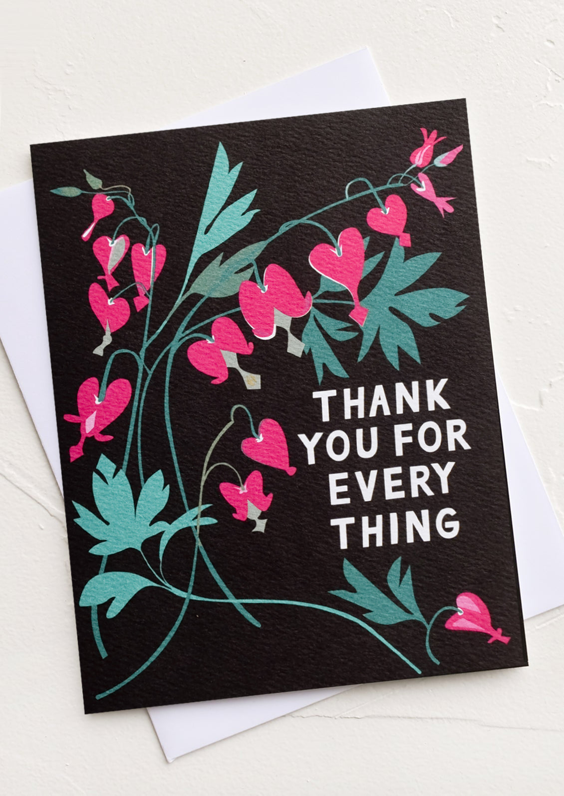 A black greeting card with illustration of bleeding heart plant and text reading "Thank you for everything".