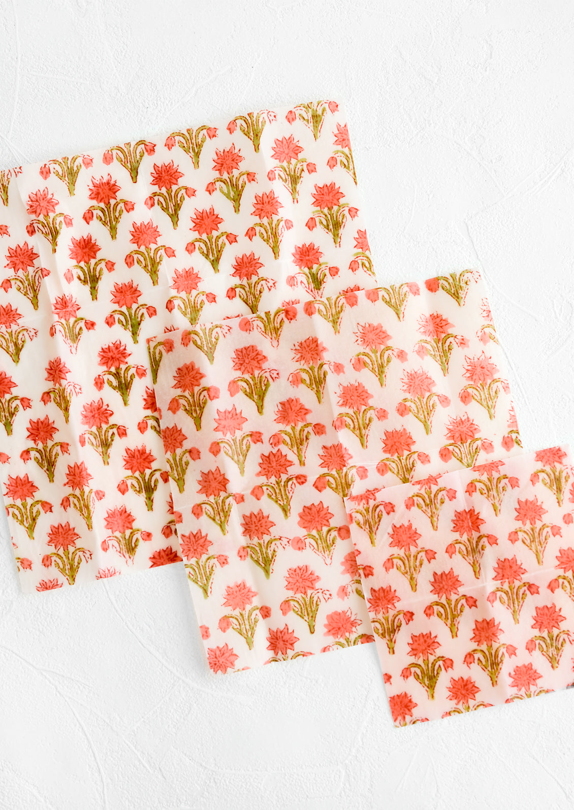 A set of three beeswax wraps with block print pattern in incremental sizes.