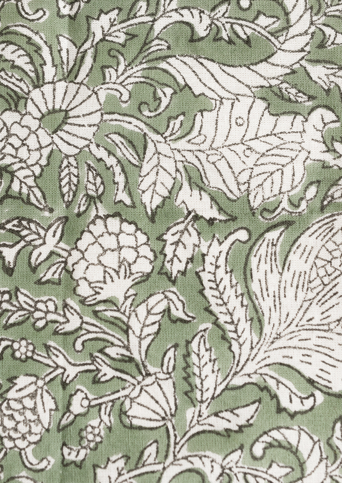 A pair of block print napkins in ivy green with black and white floral print.