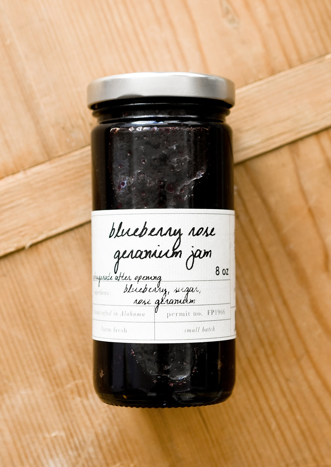 A glass jar of blueberry jam.