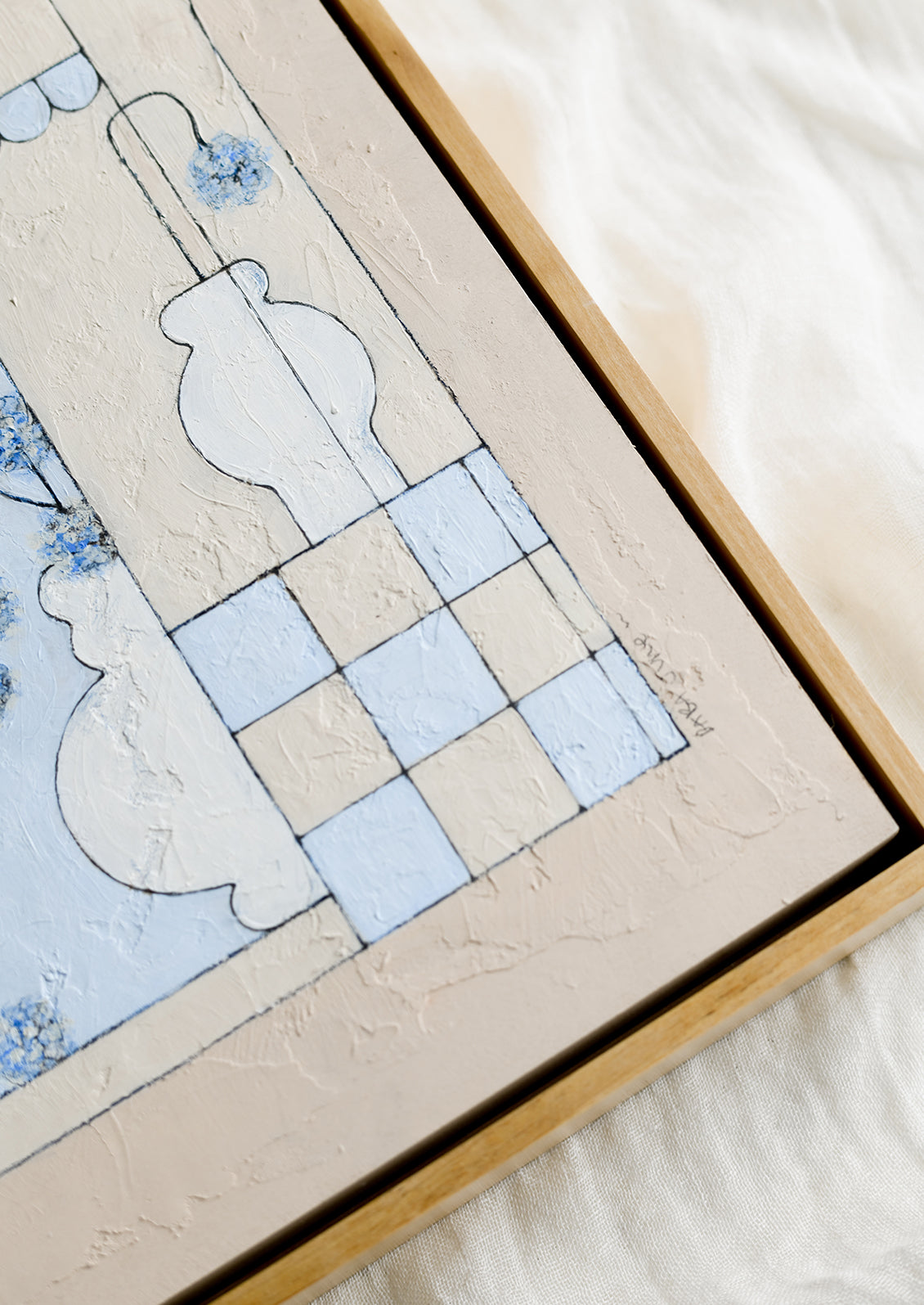 A framed original still life painting in blue and beige.