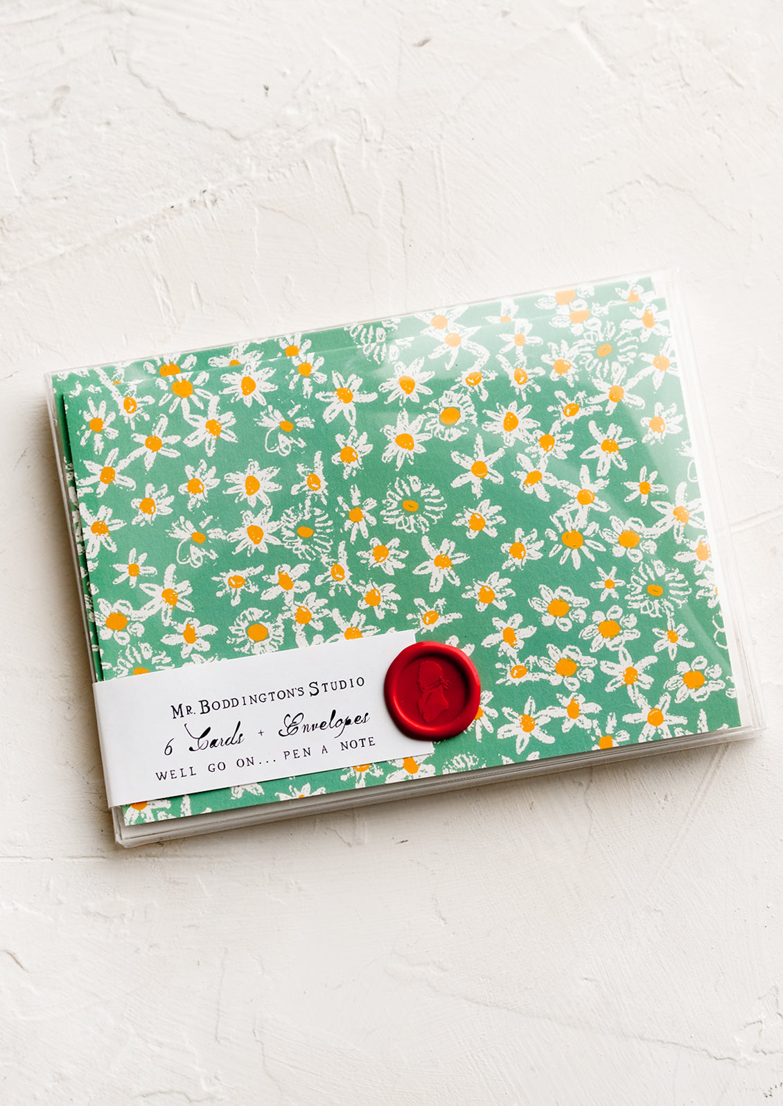 A set of green daisy print cards in box with decorative wax seal packaging.