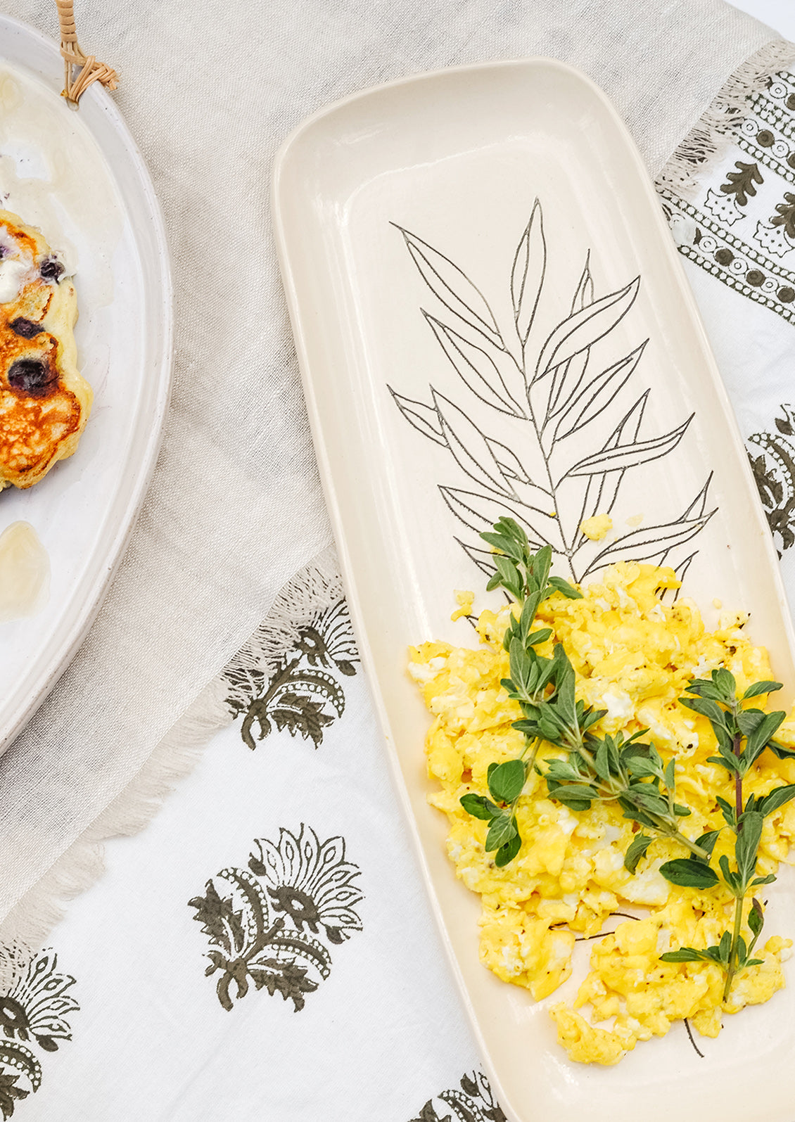A ceramic platter with scrambled eggs.