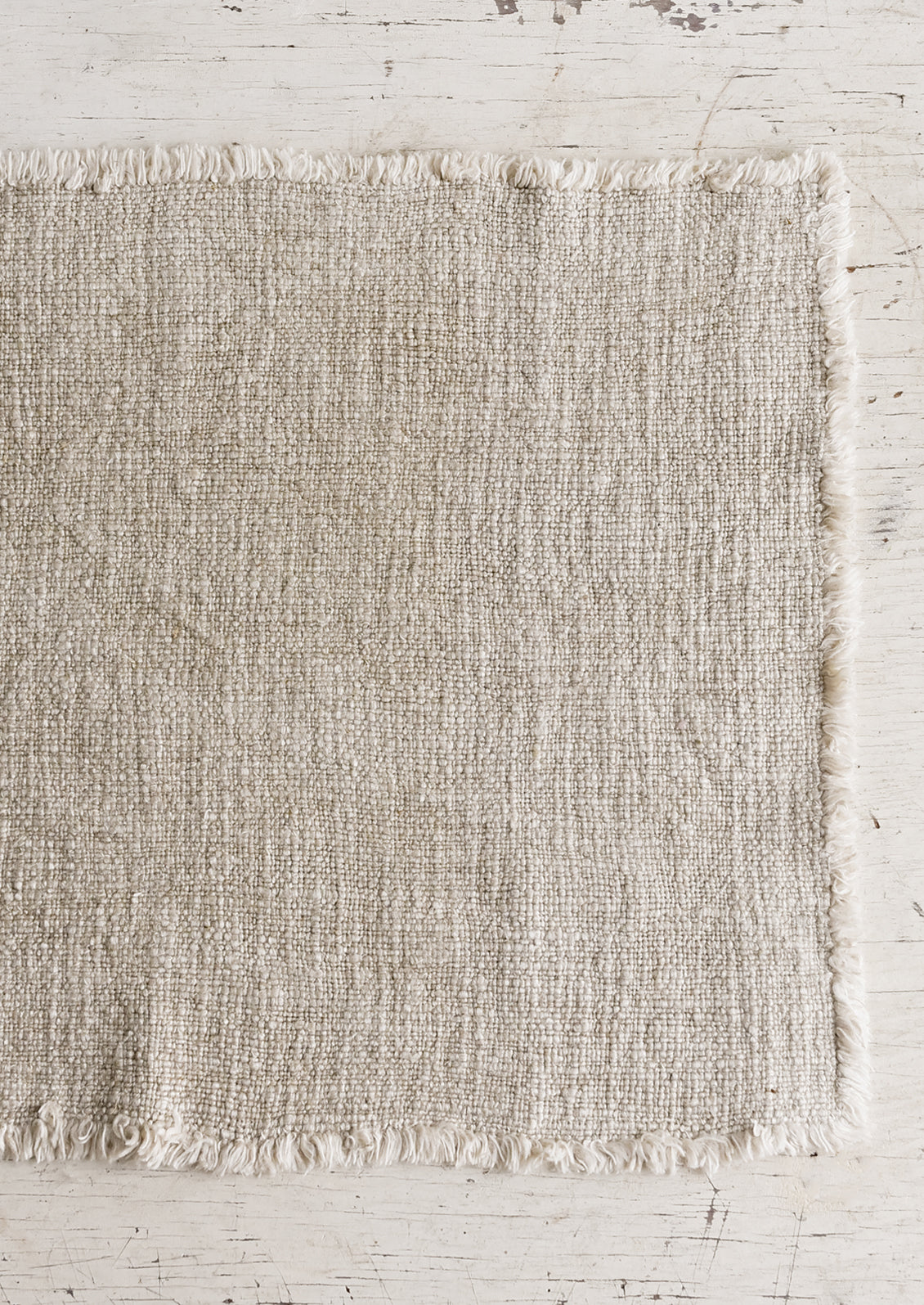 A slub boucle textured placemat in tan.