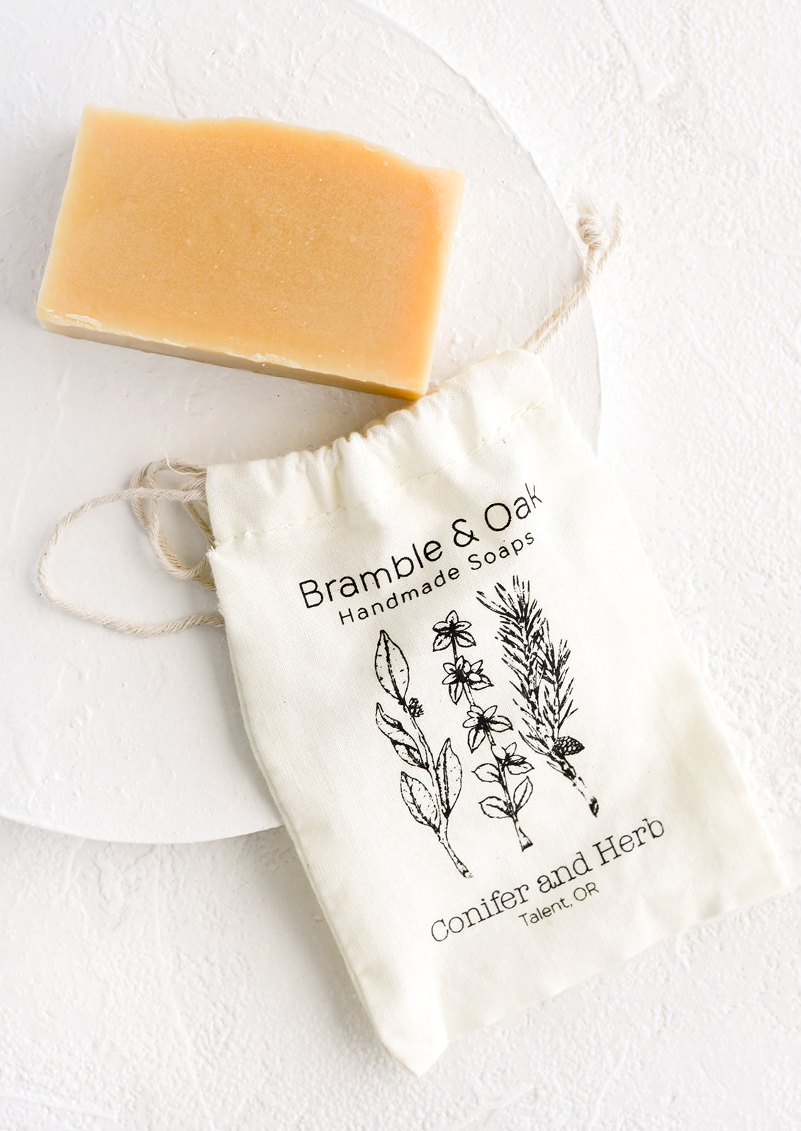 A printed muslin bag with a bar of soap.