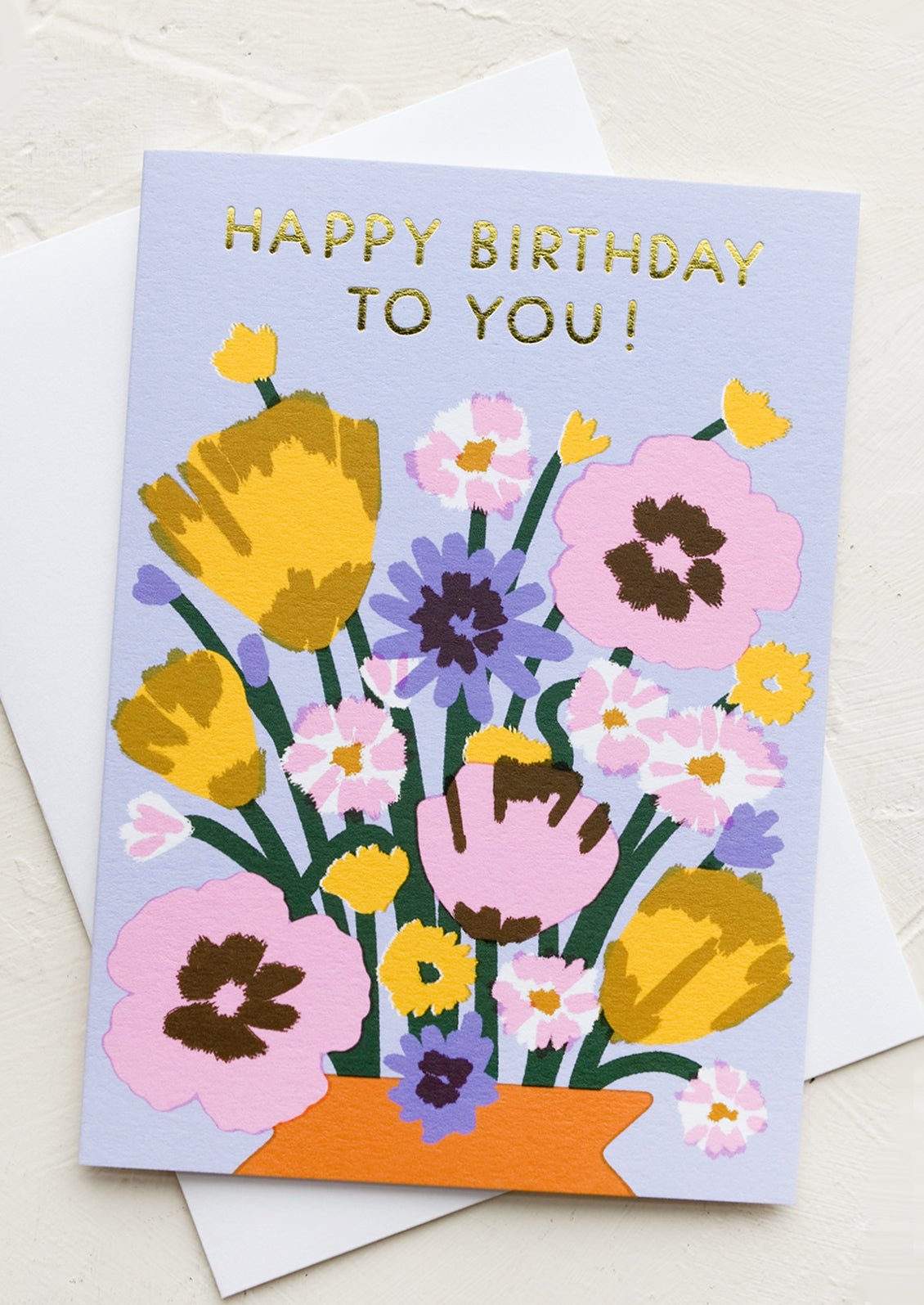 A greeting card with bright bouquet of flowers, text at top reads "Happy Birthday To You!".