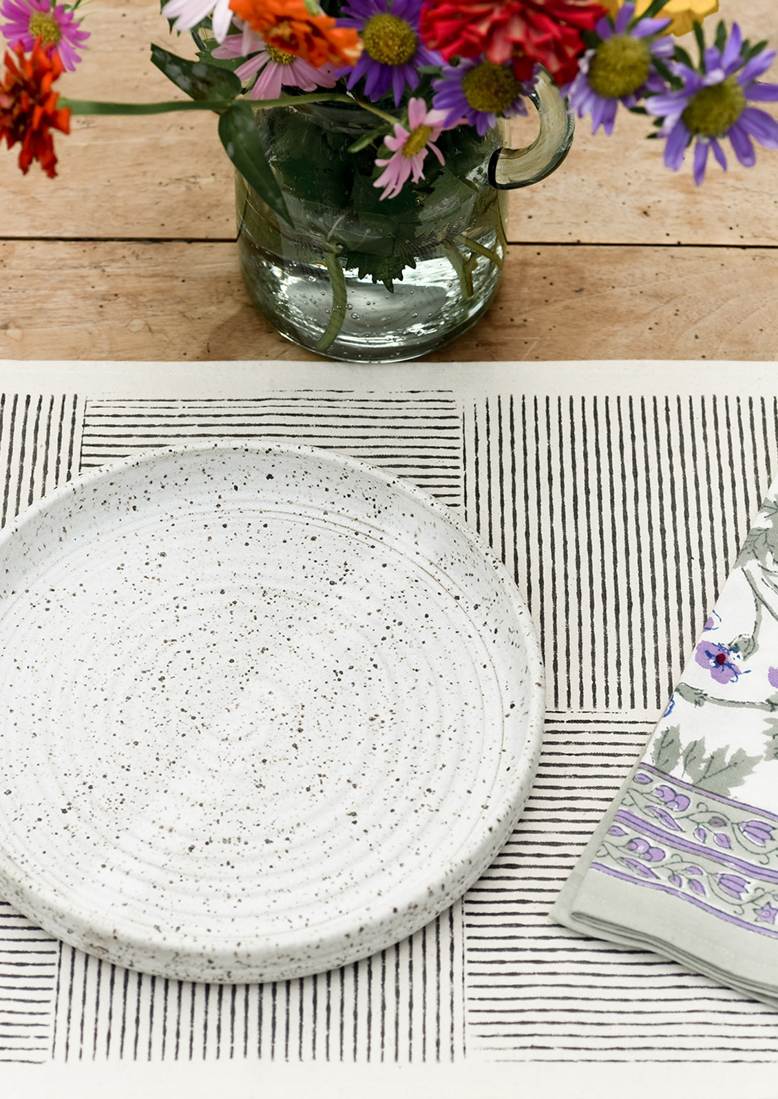 A place setting with black block printed placemat.