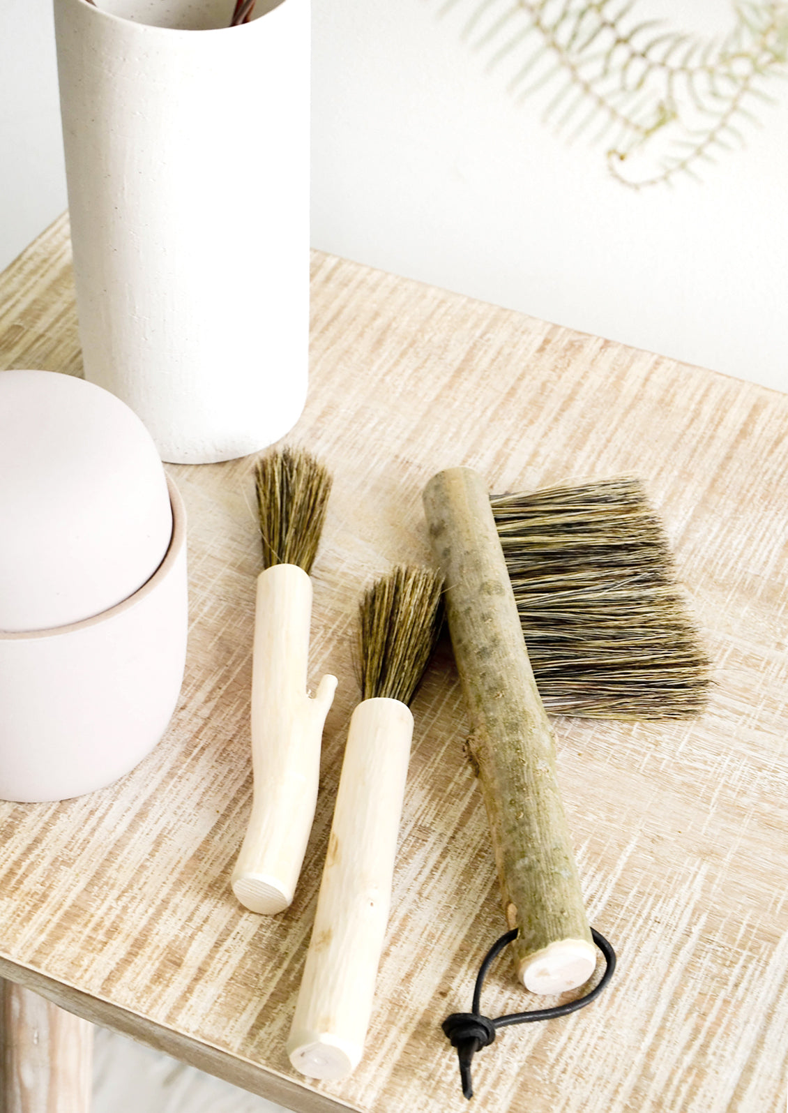 Assortment of hand carved wooden brushes on a console table