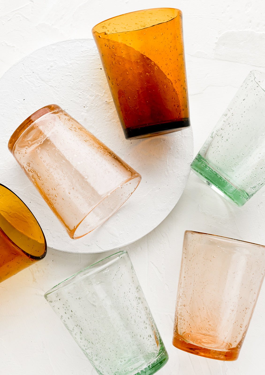 Colorful tapered glass tumblers.