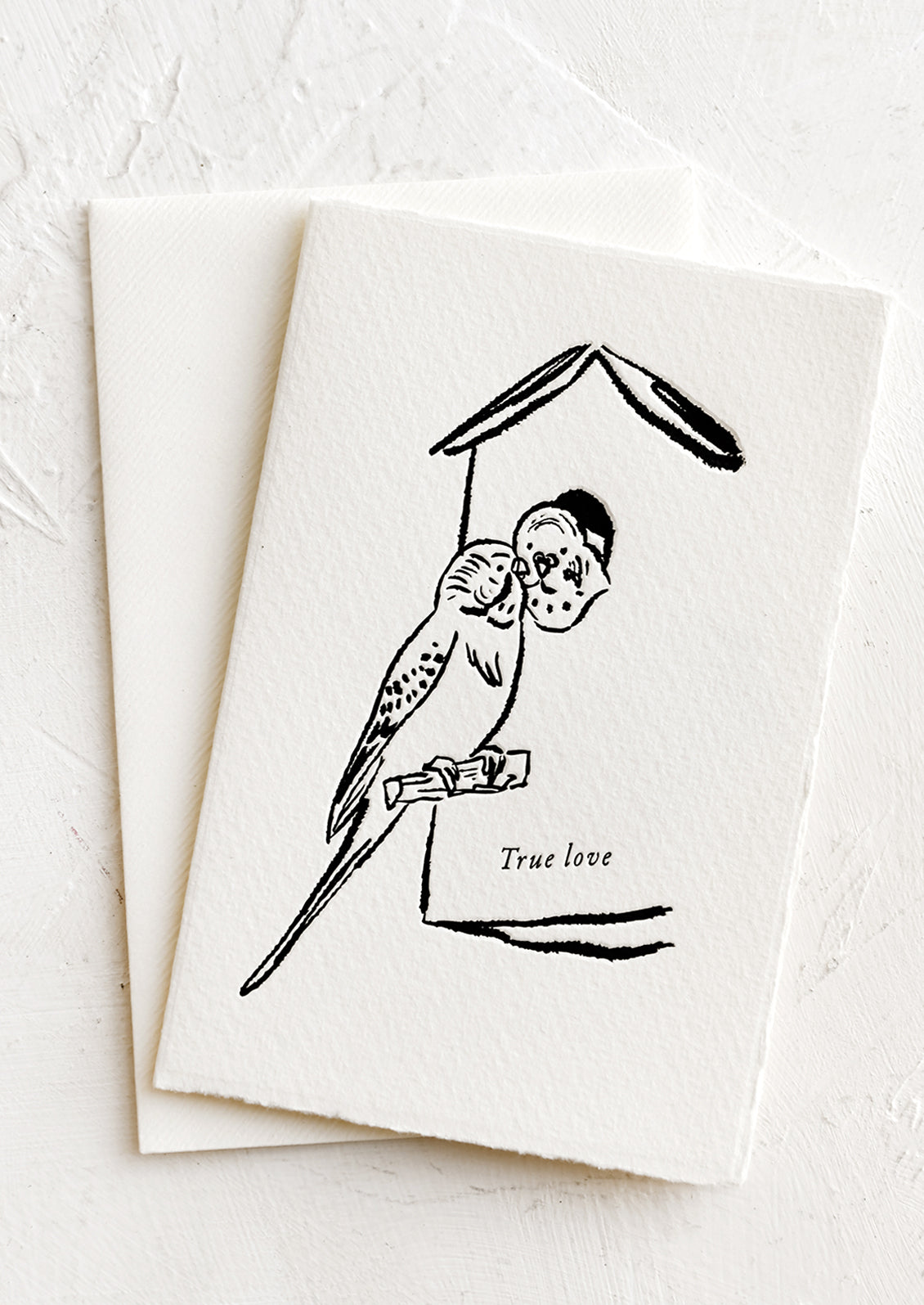 A card with image of budgie birds, text reads "True love".
