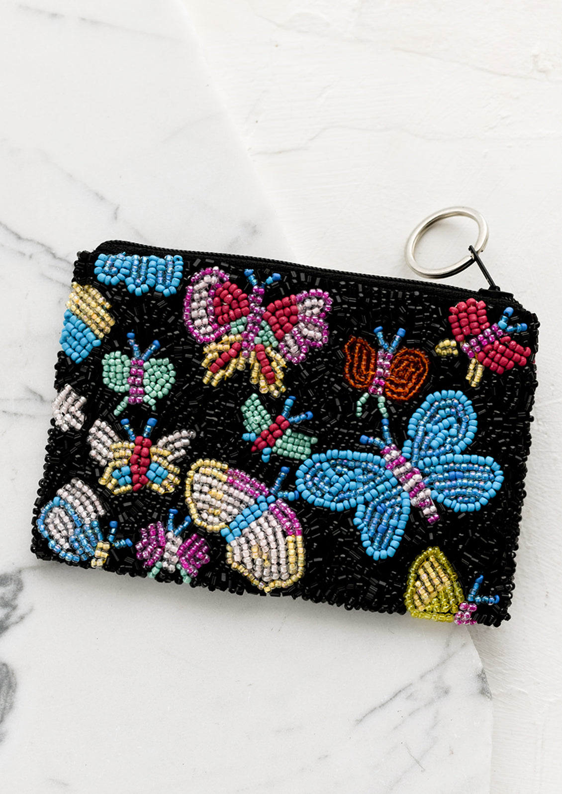 A black beaded coin pouch with colorful butterfly design.