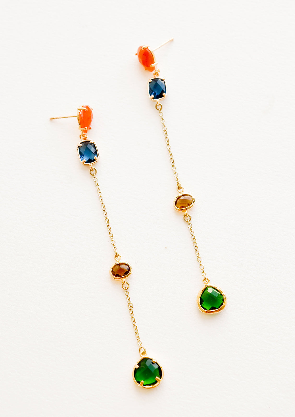 Gold drops earrings with staggered glass crystals of orange, blue, amber, and green.