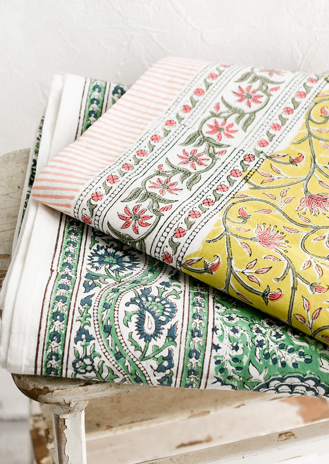 A block printed tablecloth with traditional print in blue and green shades.
